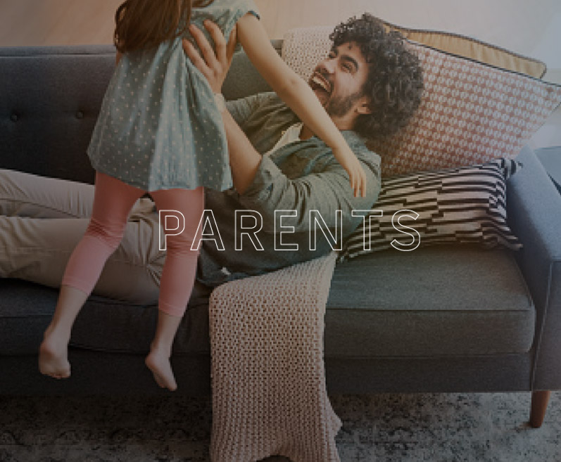 Intended parents holding their baby — helping you grow your family